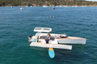 People on Nova Luxe Orphie 29 Electric Boat in the middle of a body of water with other boats in the background.