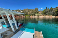 Nova Luxe Orphie 29 Electric Boat on a clear body of water with a scenic background