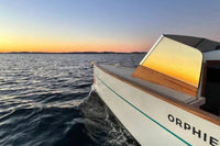 Nova Luxe Orphie 29 Electric Boat on water with sunset in the background