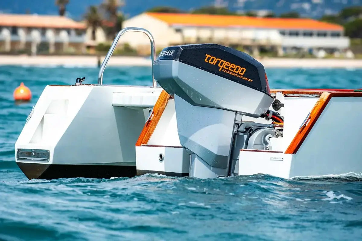 Nova Luxe Orphie 29 Electric Boat with a Torqeedo outboard motor on a body of water.
