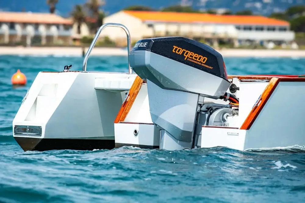 Nova Luxe Orphie 29 Electric Boat with a Torqeedo outboard motor on a body of water.