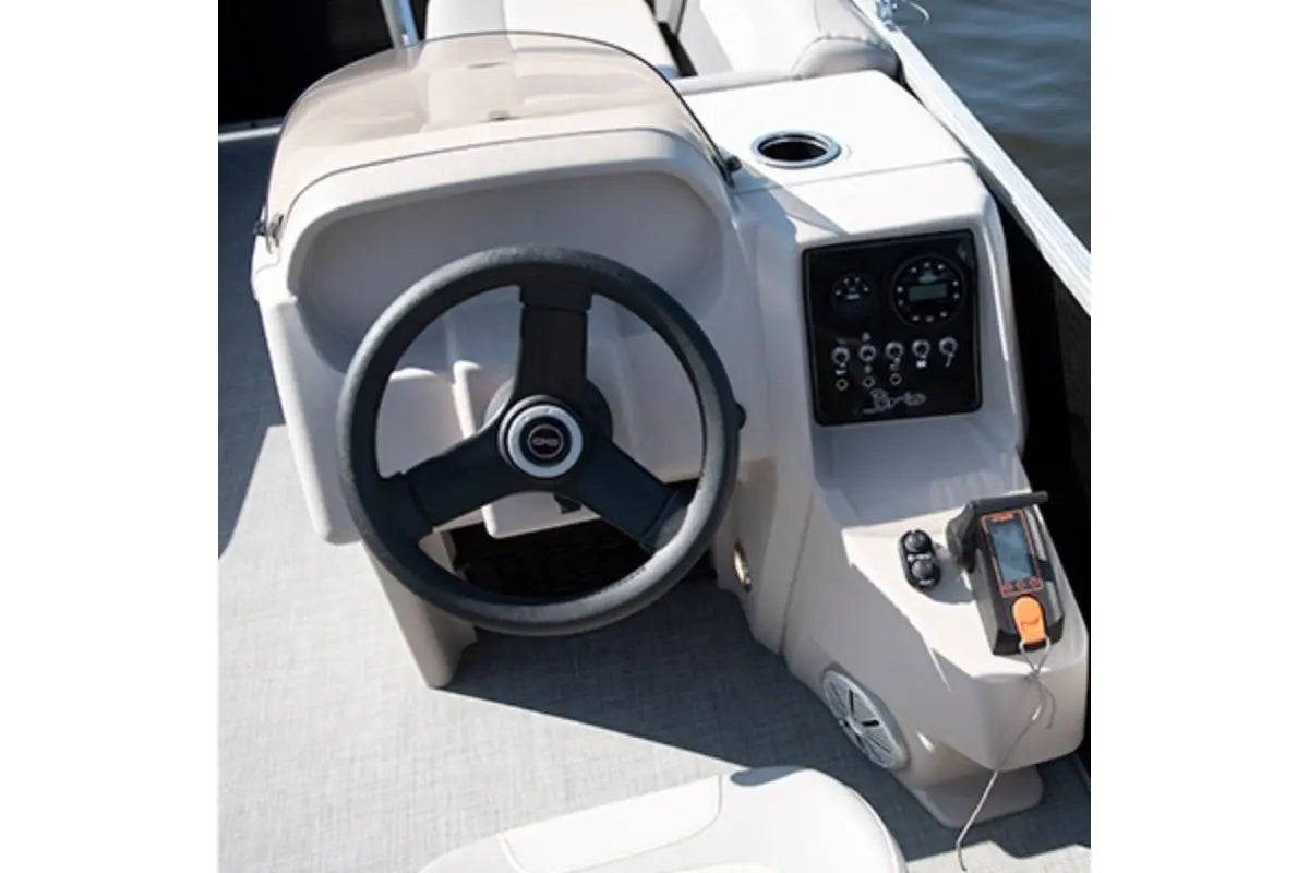 Close-up of Princecraft BrioE 19 Electric Boat steering wheel and dashboard with water in the background