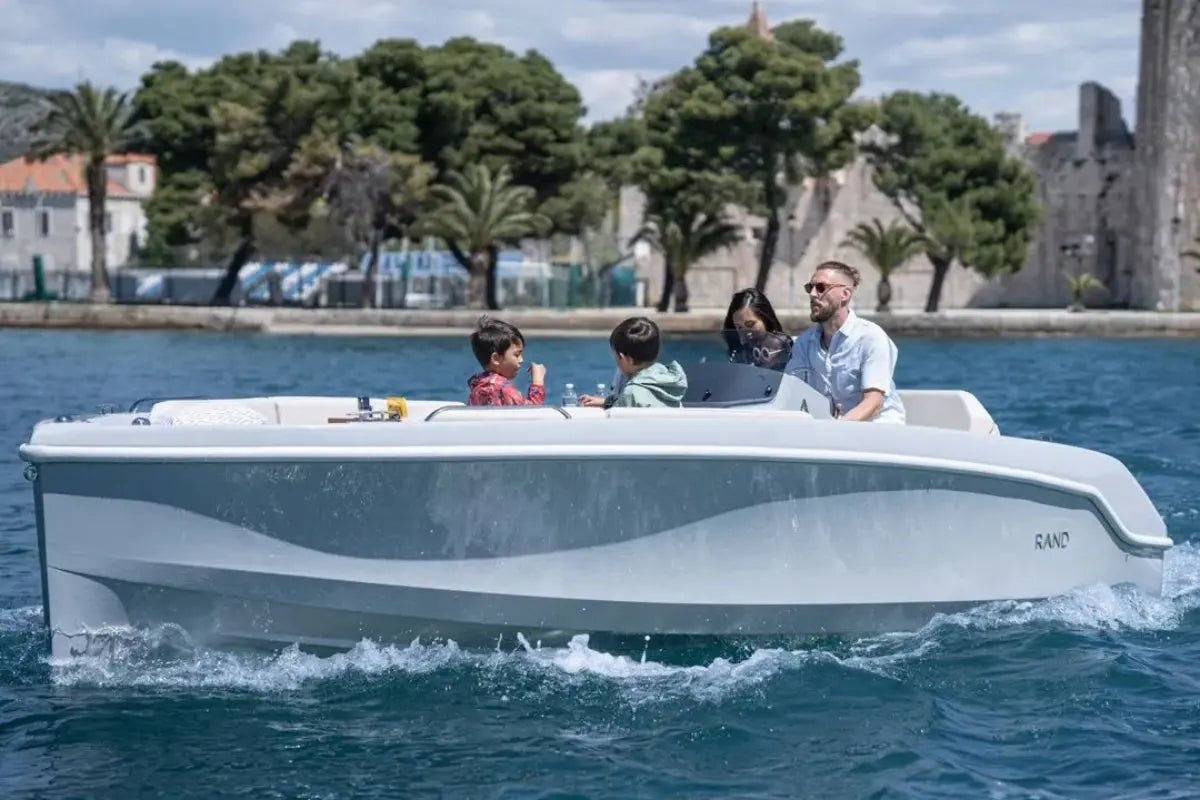 Family on a Rand Breeze 20 Electric Boat with a scenic background