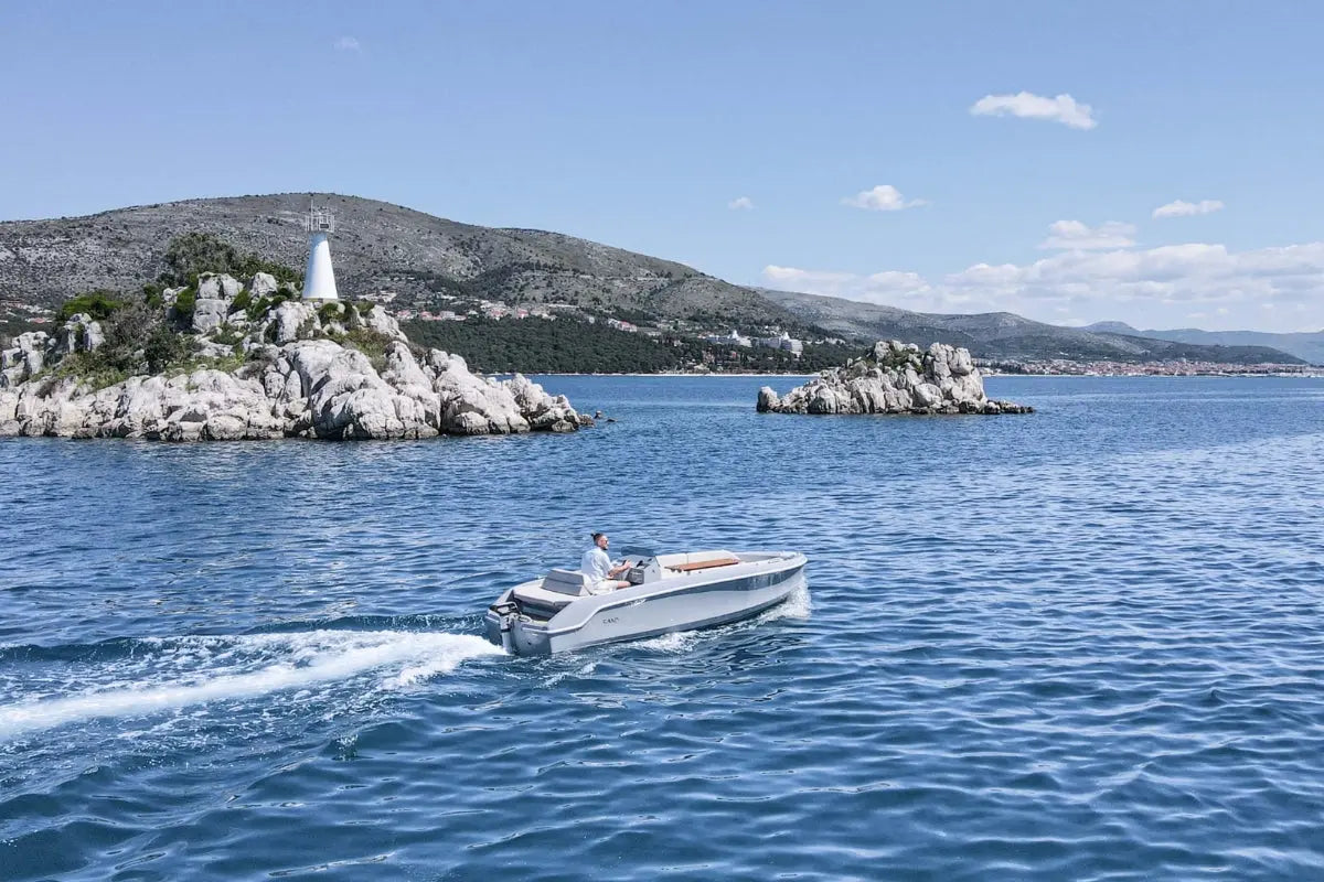 Rand Breeze 20 Electric Boat on a body of water with a scenic background