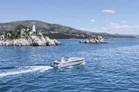 Rand Breeze 20 Electric Boat on a body of water with a scenic background