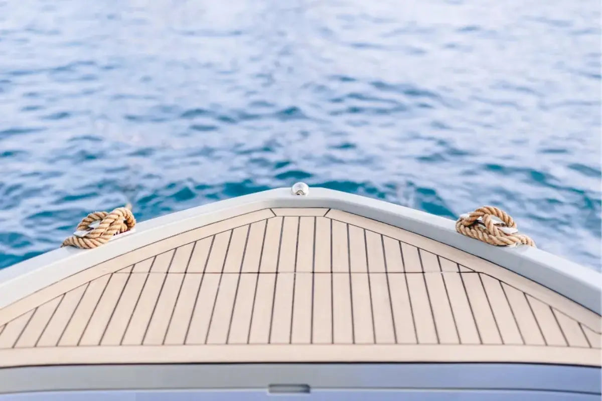 Close-up of Rand Mana 24 Electric Boat bow with ropes on a body of water