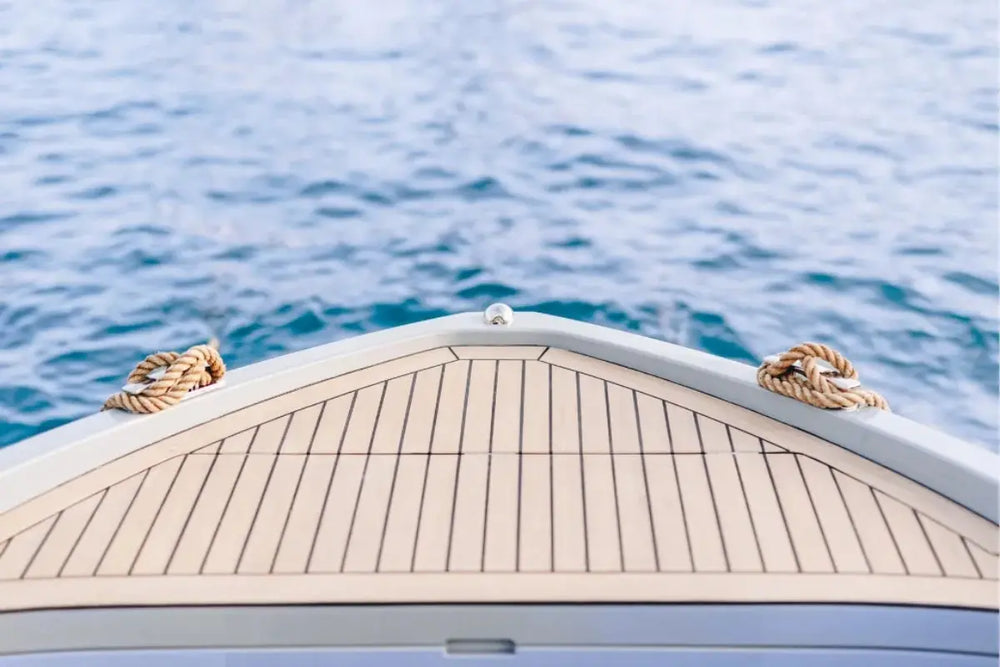 Close-up of Rand Mana 24 Electric Boat bow with ropes on a body of water