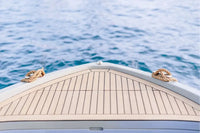 Close-up of Rand Mana 24 Electric Boat bow with ropes on a body of water