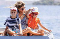 Woman and two children on Rand Mana 24 Electric Boat with a scenic background