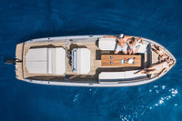 Aerial view of Rand Mana 24 Electric Boat with people on a clear blue water surface