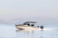 Rand Roamer 29 Electric Boat on a body of water with mountains in the background