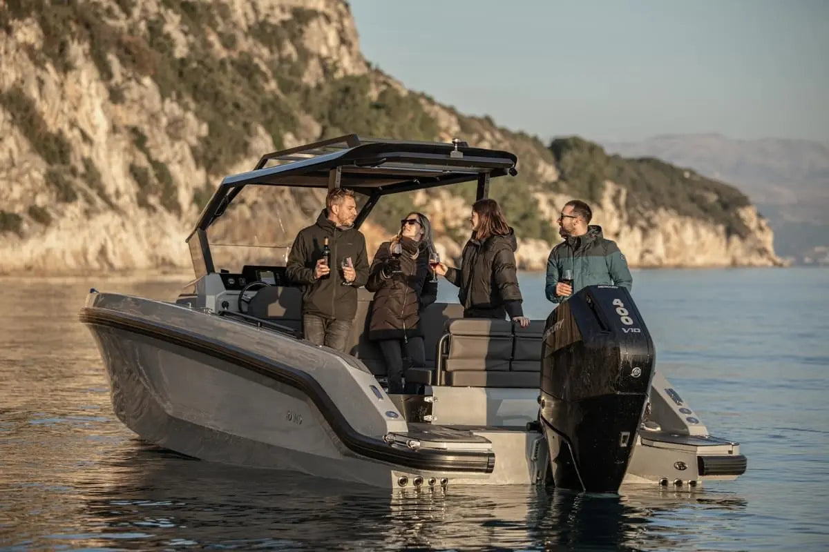 Group of people on Rand Roamer 29 Electric Boat in a scenic coastal area