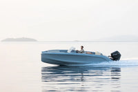 Blue Rand Source 22 Electric Boat on a calm body of water with a person inside