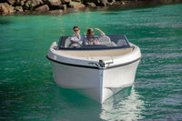 Rand Spirit 25 Electric Boat with two people on a turquoise body of water