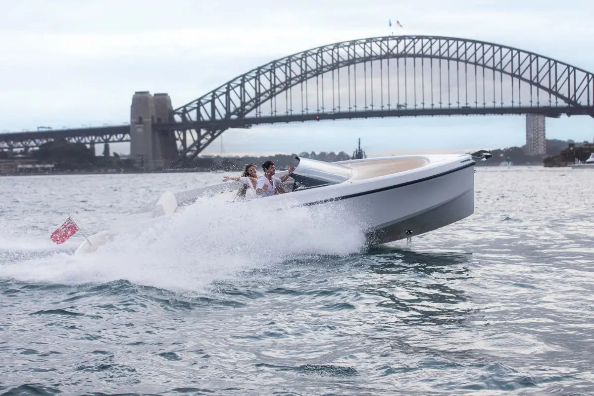 Rand Spirit 25 Electric Boat on water with Sydney Harbour Bridge in the background