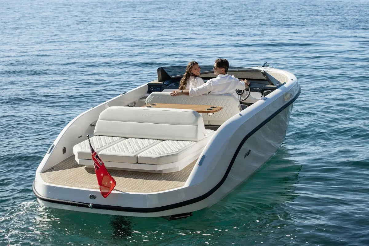 Rand Spirit 25 Electric Boat with a couple on a calm blue sea