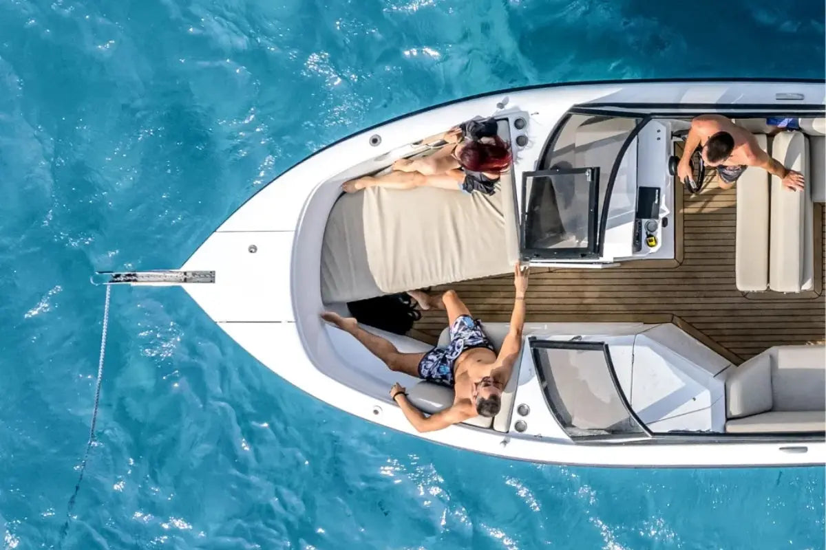 Top-down view of Rand Supreme 27 Electric Boat with people on a clear blue water surface