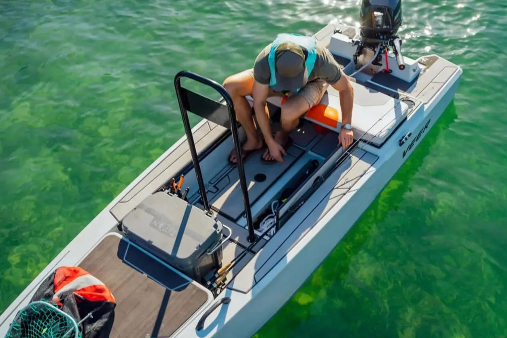 Person on Veer V13 Electric Boat in clear green water