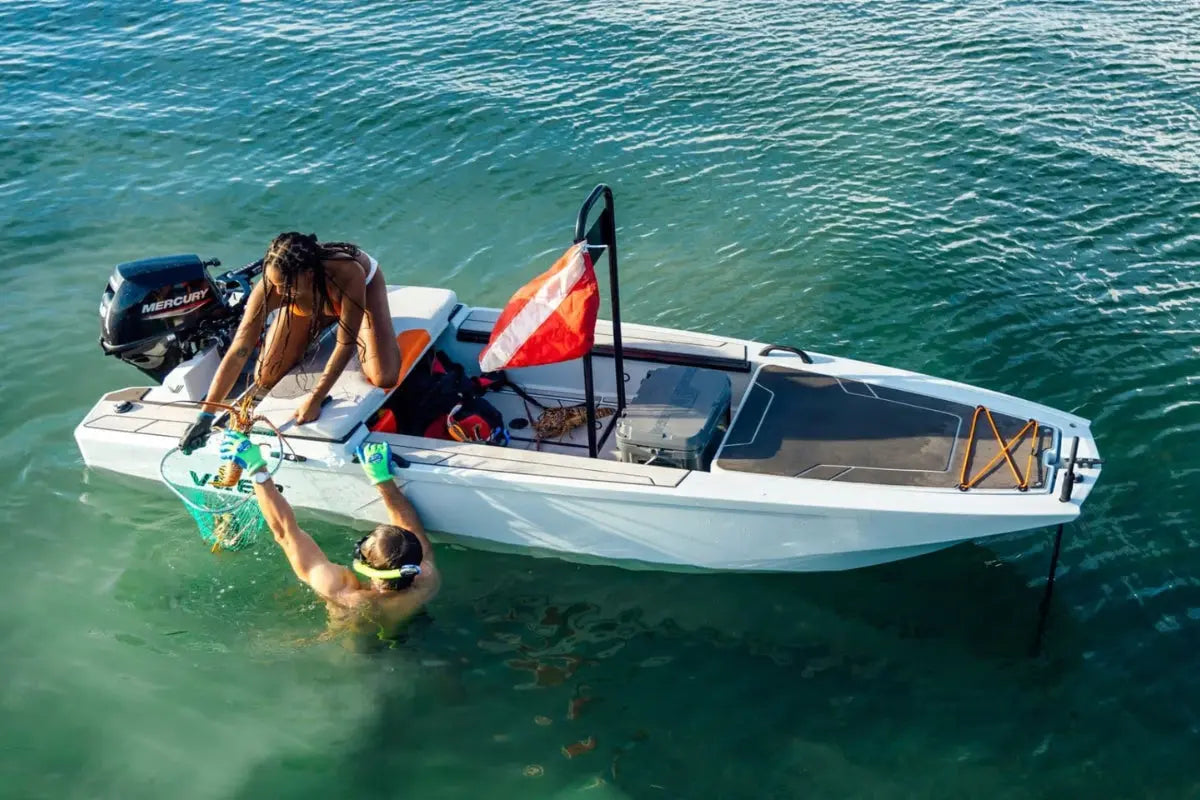 Two people with Veer V13 Electric Boat on a body of water