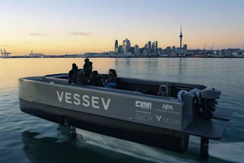 vessev electric boat on water with a city skyline