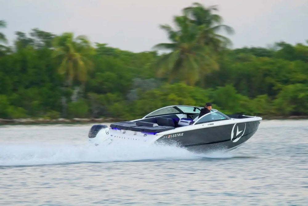 Vision H2e Bowrider Electric Boat on water with trees in the background
