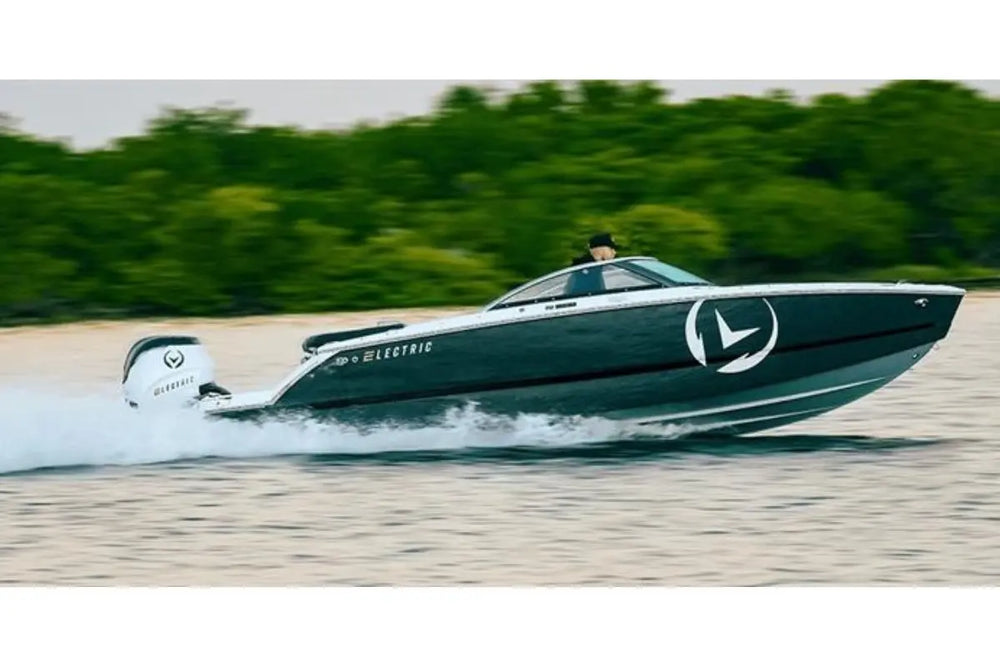 Vision H2e Bowrider Electric Boat with a logo on the water near a forest