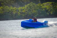 Person in Vision Phantom Electric Boat on a lake with trees in the background