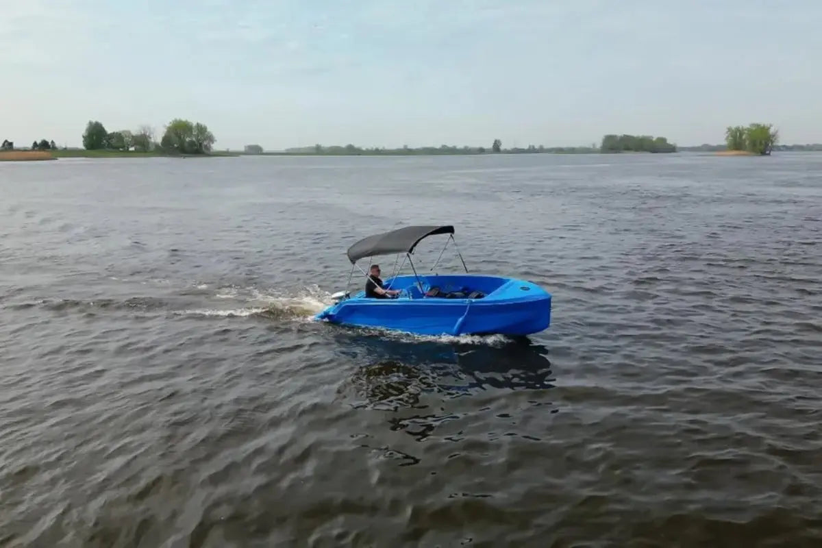 Vision Phantom Electric Boat with a canopy on a body of water under a clear sky