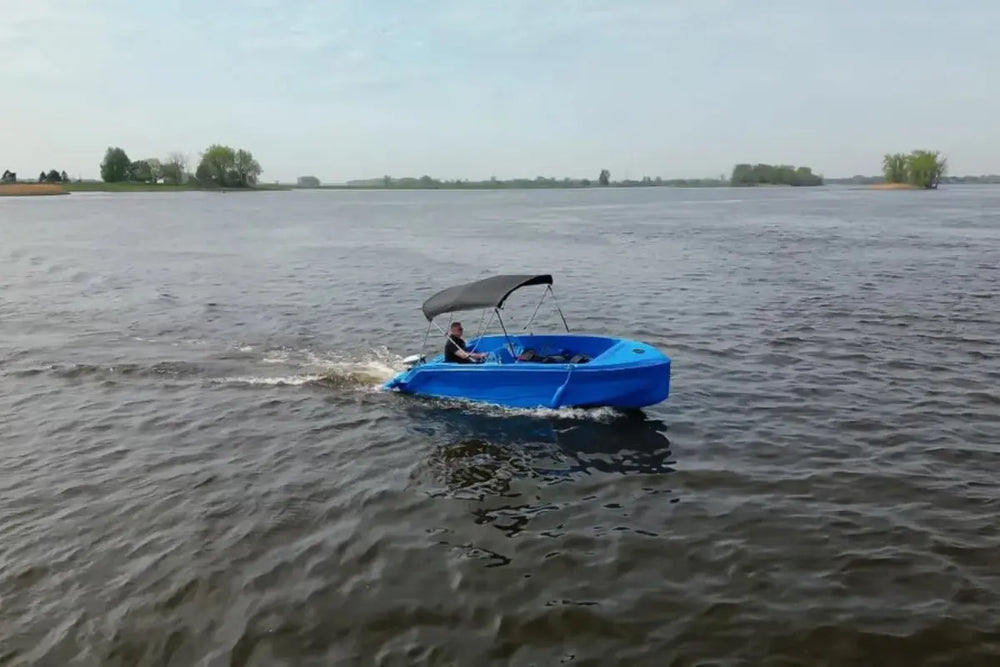 Vision Phantom Electric Boat with a canopy on a body of water under a clear sky