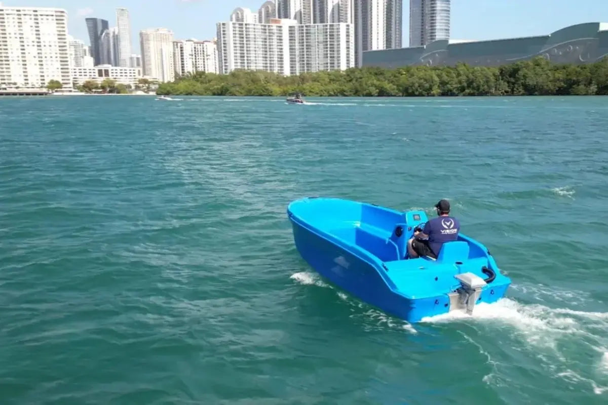 Vision Phantom Electric Boat on a body of water with a city skyline in the background
