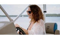 Woman driving Vision V17 Electric Boat on a lake