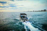 Vision V30 Electric Boat on the water with a city skyline in the background
