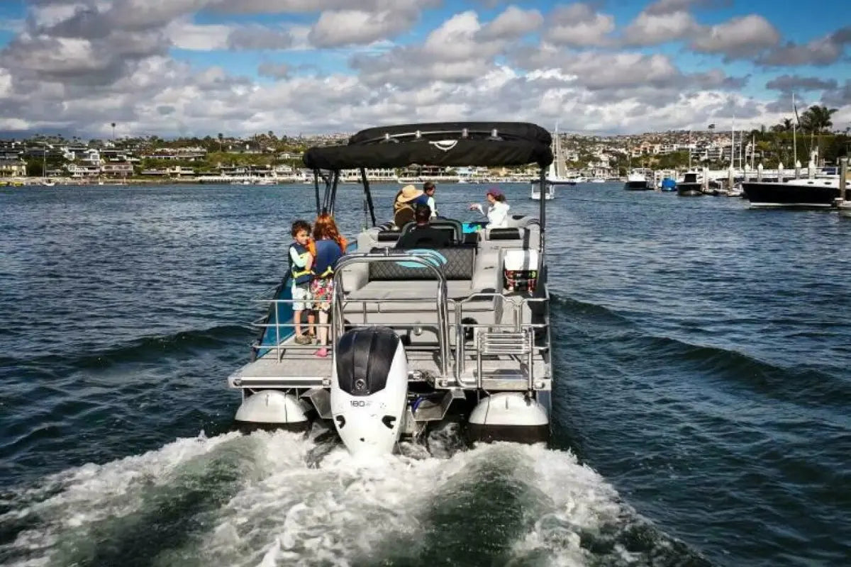 Vision V30 Electric Boat with people on a body of water under a cloudy sky