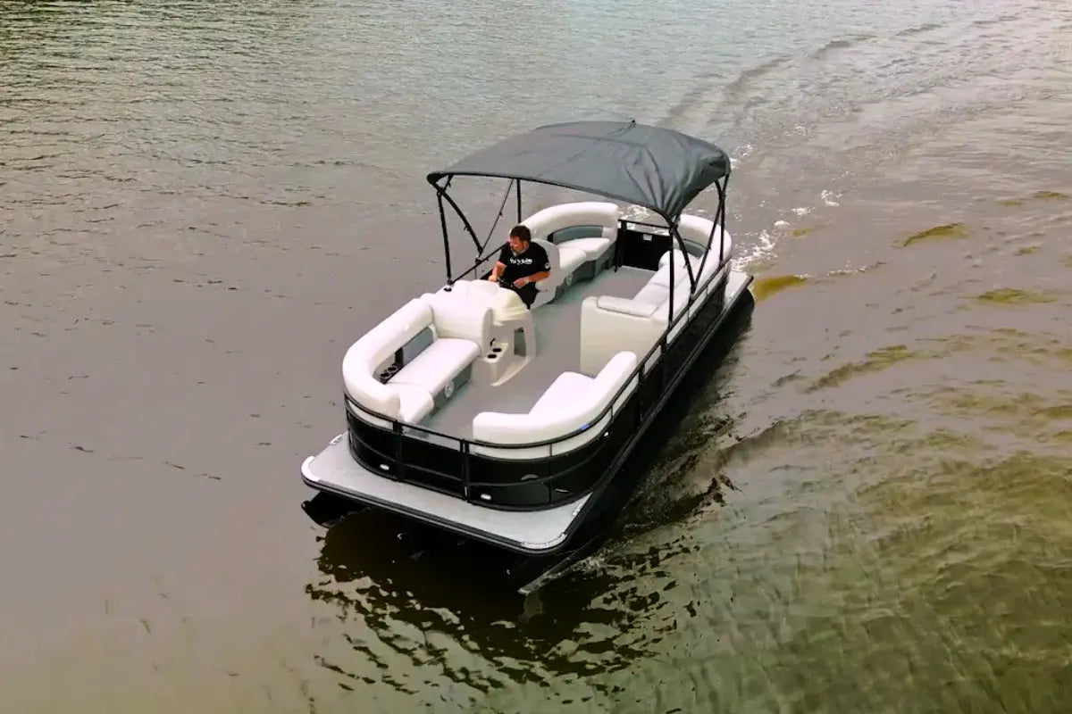 Vision WX Tritoon Electric Boat with a canopy on a body of water