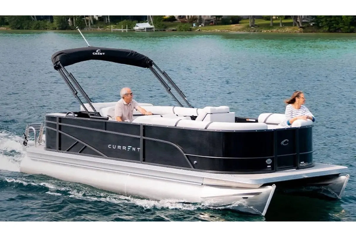 Vision WX Tritoon Electric Boat on a lake with people inside, featuring the Curraty brand.