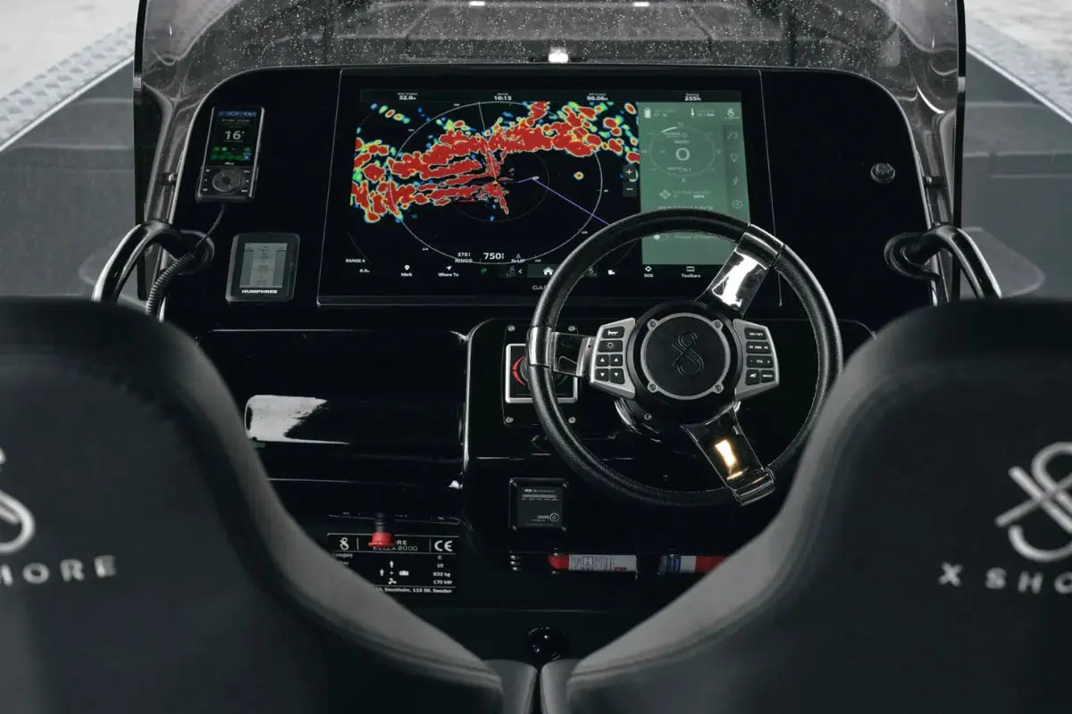 X Shore Pro Electric Boat cockpit with digital display and steering wheel, featuring the brand 'X Shox'.