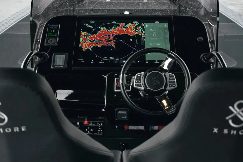 X Shore Pro Electric Boat cockpit with digital display and steering wheel, featuring the brand 'X Shox'.