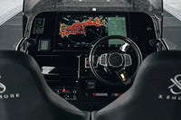 X Shore Pro Electric Boat cockpit with digital display and steering wheel, featuring the brand 'X Shox'.