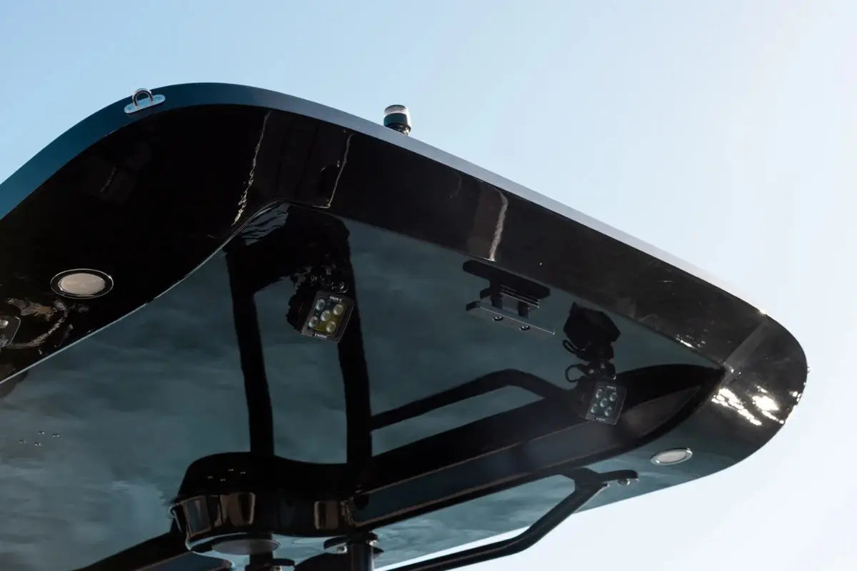 Close-up of X Shore Pro Electric Boat reflective metal surface with a clear blue sky background