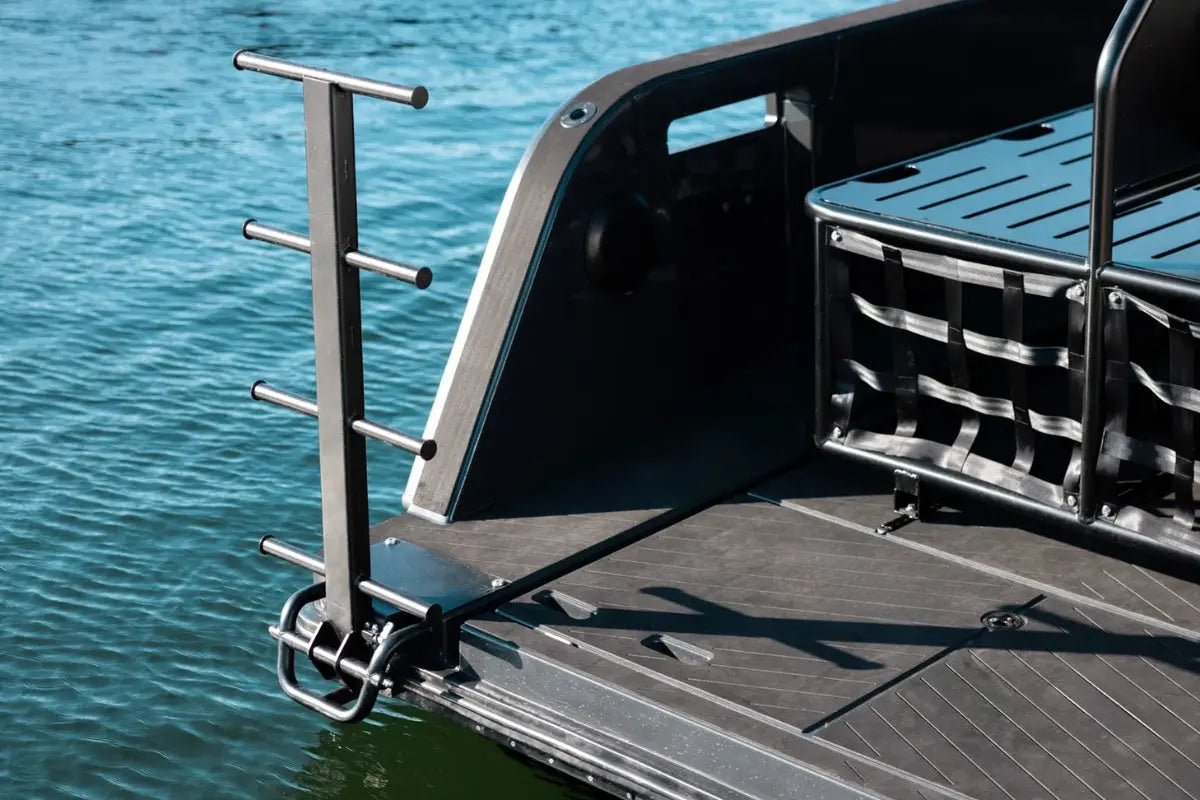 X Shore Pro Electric Boat deck with a ladder and storage rack against a water background