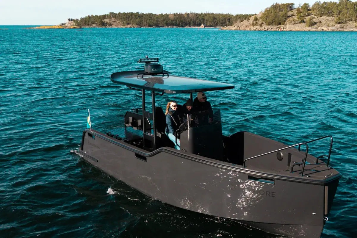 X Shore Pro Electric Boat on a body of water with a scenic background